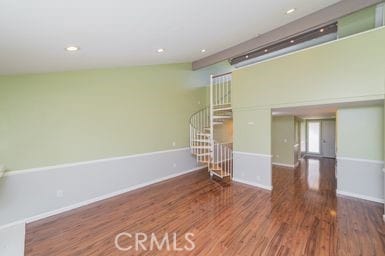 14 Featherwood, Irvine, CA 92612 - unfurnished living room with wood finished floors, stairs, and recessed lighting