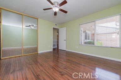 14 Featherwood, Irvine, CA 92612 - unfurnished bedroom with wood finished floors, multiple windows, and a closet