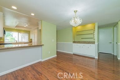 14 Featherwood, Irvine, CA 92612 - unfurnished dining area featuring wood finished floors, a chandelier, and recessed lighting