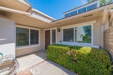 14 Featherwood, Irvine, CA 92612 - doorway to property with stucco siding