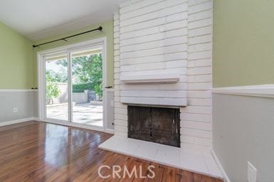 14 Featherwood, Irvine, CA 92612 - unfurnished living room with a large fireplace and wood finished floors