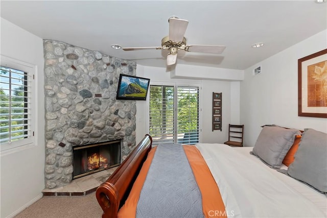 544 Old Toll Rd, Lake Arrowhead, CA 92352 - carpeted bedroom with access to exterior, a stone fireplace, and ceiling fan