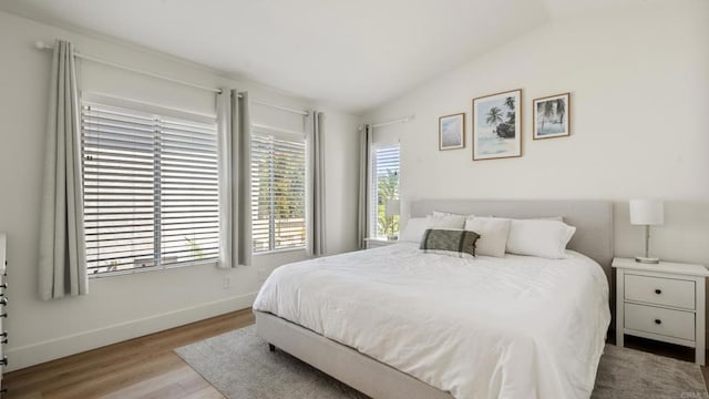 4058 Ivey Vista Way, Oceanside, CA 92057 - bedroom featuring vaulted ceiling, multiple windows, and wood finished floors