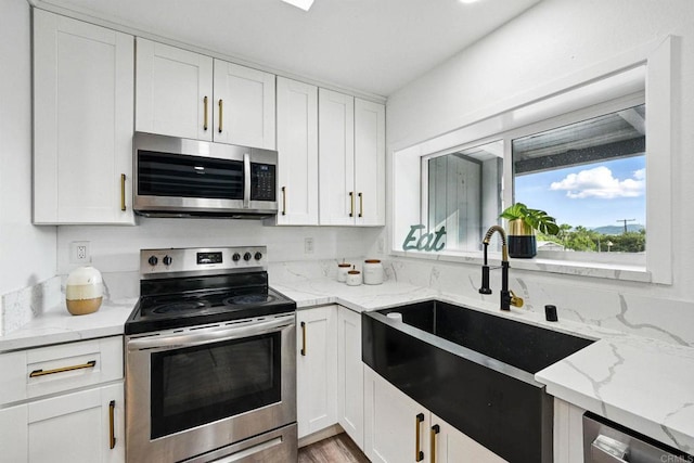 12049 Coping Pl, Lakeside, CA 92040 - kitchen with stainless steel appliances, white cabinetry, and light stone countertops