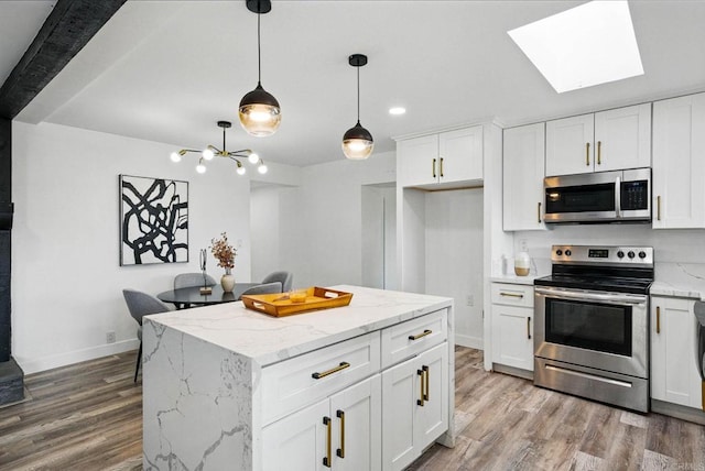 12049 Coping Pl, Lakeside, CA 92040 - kitchen with stainless steel appliances, wood finished floors, white cabinets, hanging light fixtures, and recessed lighting