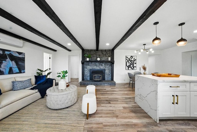 12049 Coping Pl, Lakeside, CA 92040 - living area featuring a wall unit AC, light wood-style floors, beamed ceiling, a stone fireplace, and recessed lighting