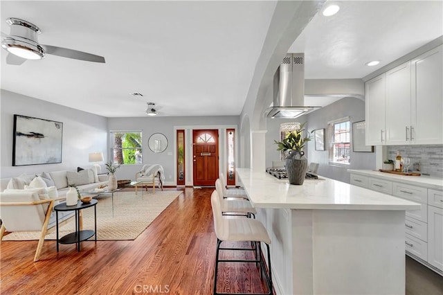 218 Covina Ave, Long Beach, CA 90803 - kitchen featuring island exhaust hood, open floor plan, stainless steel gas stovetop, healthy amount of natural light, and recessed lighting