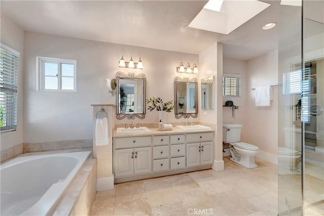 218 Covina Ave, Long Beach, CA 90803 - bathroom featuring a garden tub, double vanity, a stall shower, a skylight, and tile patterned flooring