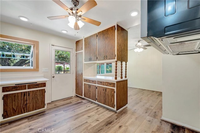 13925 Belgate St, Baldwin Park, CA 91706 - kitchen featuring ceiling fan, light wood-style floors, light countertops, brown cabinets, and recessed lighting