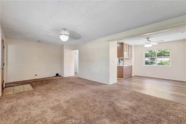 13925 Belgate St, Baldwin Park, CA 91706 - unfurnished living room featuring light colored carpet, a textured ceiling, and a ceiling fan