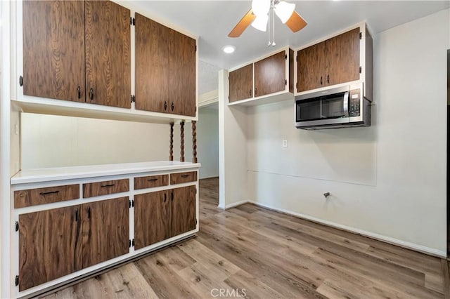 13925 Belgate St, Baldwin Park, CA 91706 - kitchen with stainless steel microwave, light wood finished floors, ceiling fan, and recessed lighting