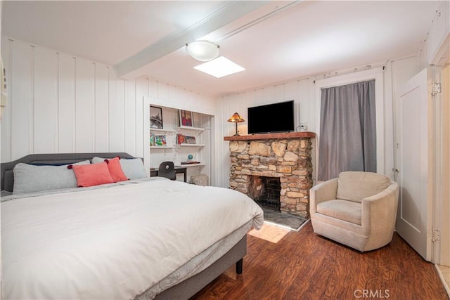 1551 N Beverly Glen Blvd, Los Angeles, CA 90077 - bedroom with wood finished floors, beam ceiling, and a fireplace