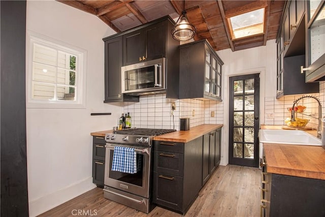 1551 N Beverly Glen Blvd, Los Angeles, CA 90077 - kitchen featuring wooden counters, stainless steel appliances, healthy amount of natural light, light wood finished floors, and wood ceiling