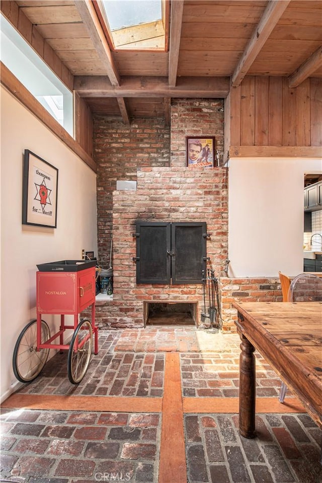 1551 N Beverly Glen Blvd, Los Angeles, CA 90077 - living room featuring brick flooring, a wooden ceiling with exposed beams, and a fireplace