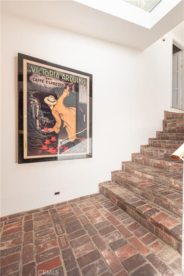 1551 N Beverly Glen Blvd, Los Angeles, CA 90077 - stairs featuring a skylight and brick flooring