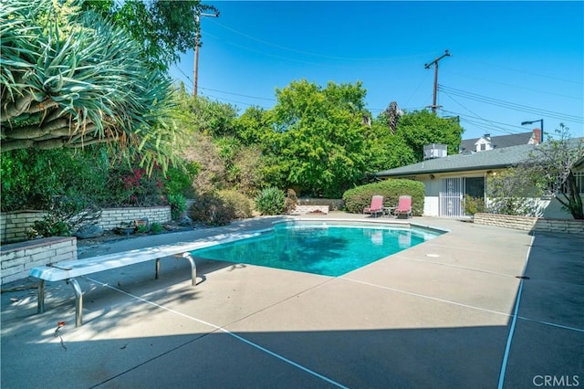 211 Peacock Ln, Montebello, CA 90640 - view of swimming pool with a diving board and a patio