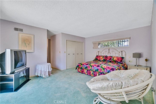 211 Peacock Ln, Montebello, CA 90640 - bedroom featuring a textured ceiling, carpet, and a closet