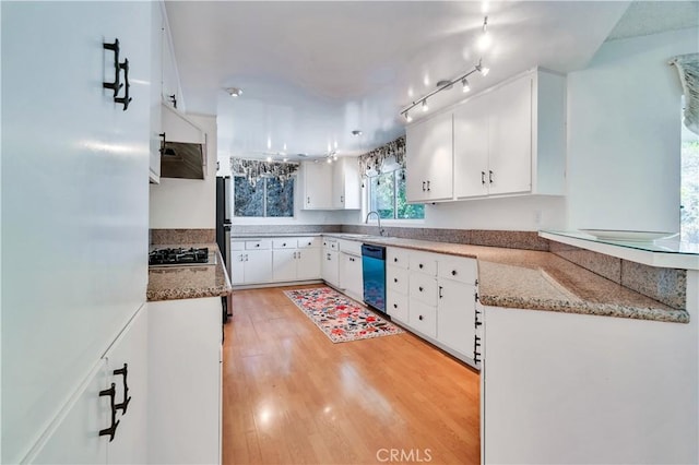 211 Peacock Ln, Montebello, CA 90640 - kitchen featuring dishwashing machine, black gas stovetop, light wood-type flooring, white cabinetry, and freestanding refrigerator