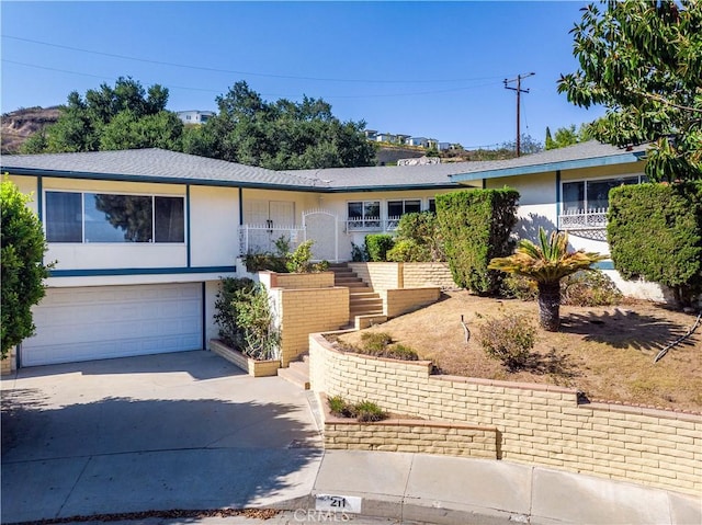 211 Peacock Ln, Montebello, CA 90640 - single story home featuring driveway, stairway, a garage, and stucco siding