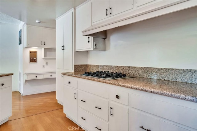 211 Peacock Ln, Montebello, CA 90640 - kitchen with stainless steel gas stovetop, light wood-style flooring, and white cabinetry