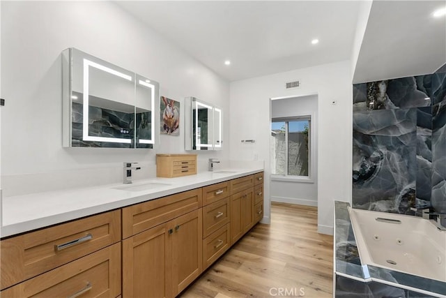 416 Via Pichon, San Clemente, CA 92672 - full bath featuring double vanity, a jetted tub, wood finished floors, and recessed lighting