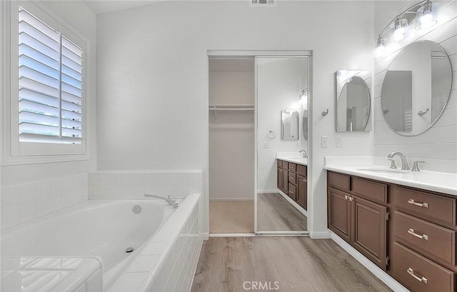 16410 Argent Rd, Chino Hills, CA 91709 - bathroom featuring wood finished floors, two vanities, and a bath