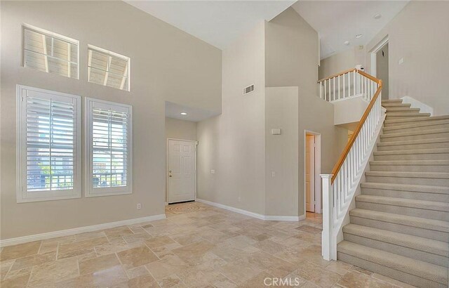 16410 Argent Rd, Chino Hills, CA 91709 - foyer entrance featuring light stone finish flooring, a towering ceiling, and stairs