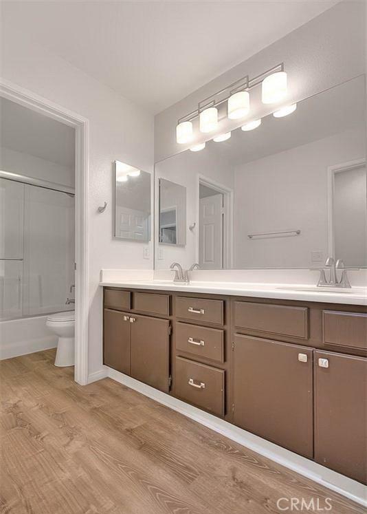 16410 Argent Rd, Chino Hills, CA 91709 - full bathroom with double vanity, wood finished floors, and bathing tub / shower combination