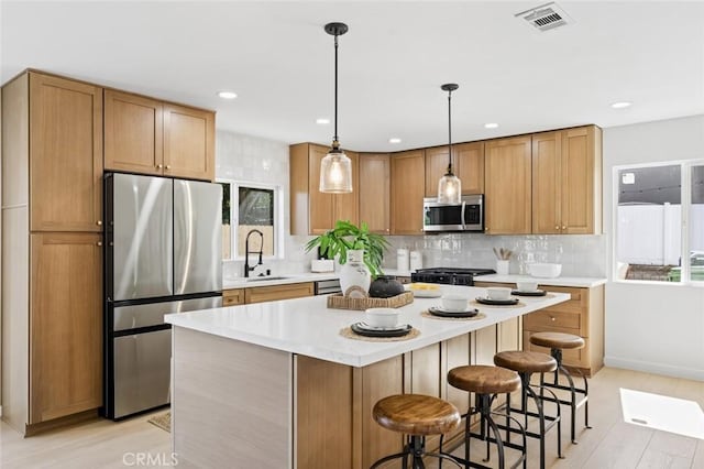 17978 Gallineta St, Rowland Heights, CA 91748 - kitchen featuring stainless steel appliances, decorative backsplash, light countertops, a breakfast bar area, and recessed lighting
