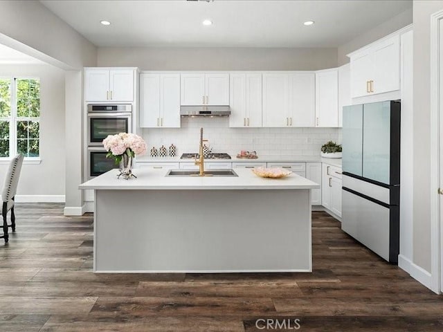 23808 Bayview Ct, Valencia, CA 91355 - kitchen with stainless steel appliances, under cabinet range hood, light countertops, backsplash, and recessed lighting