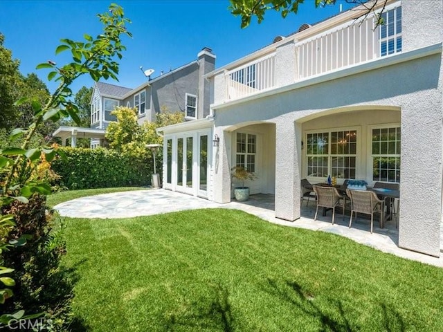 23808 Bayview Ct, Valencia, CA 91355 - rear view of house with a patio area, a balcony, a yard, and stucco siding