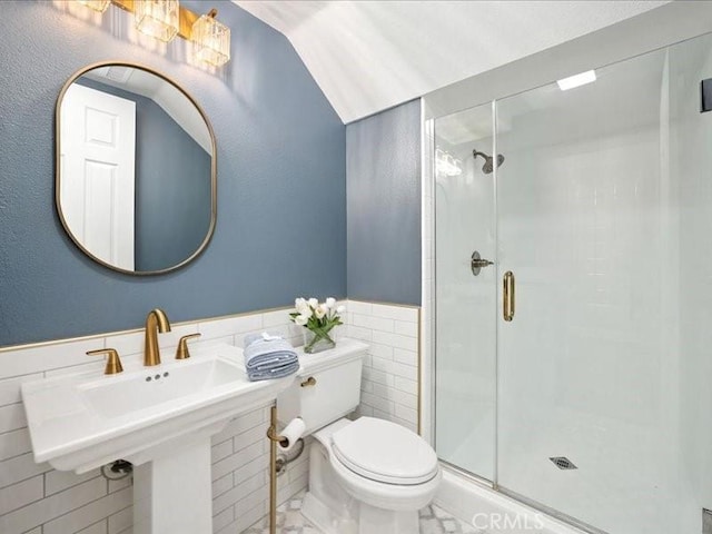23808 Bayview Ct, Valencia, CA 91355 - bathroom featuring tile walls, a stall shower, marble finish flooring, wainscoting, and lofted ceiling