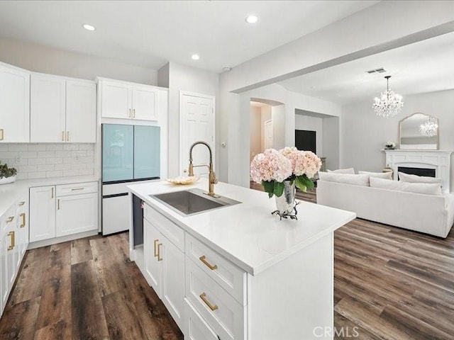 23808 Bayview Ct, Valencia, CA 91355 - kitchen with white refrigerator, dark wood-type flooring, recessed lighting, white cabinets, and decorative backsplash