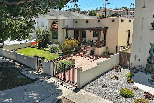 1215 S Patton Ave, San Pedro, CA 90731 - view of front of home with a gate, stucco siding, a fenced front yard, and covered porch