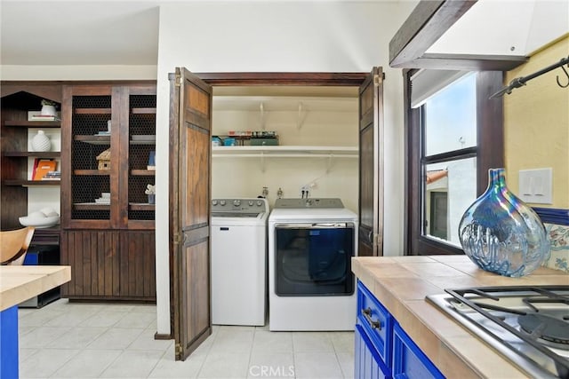 1215 S Patton Ave, San Pedro, CA 90731 - laundry area featuring washing machine and clothes dryer and light tile patterned floors