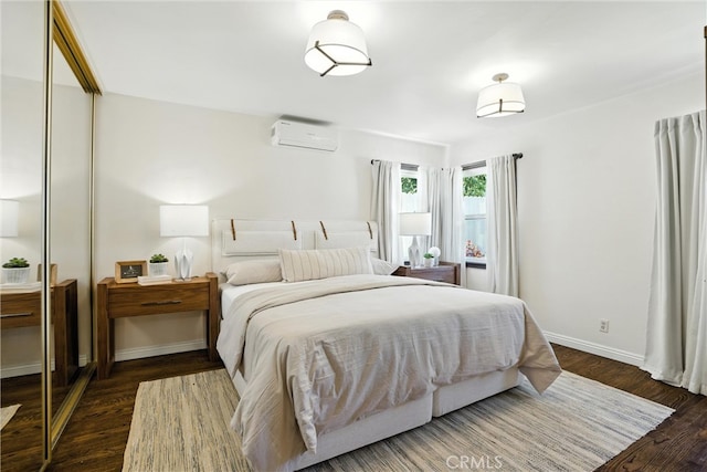 1215 S Patton Ave, San Pedro, CA 90731 - bedroom featuring a wall unit AC, wood finished floors, and a closet