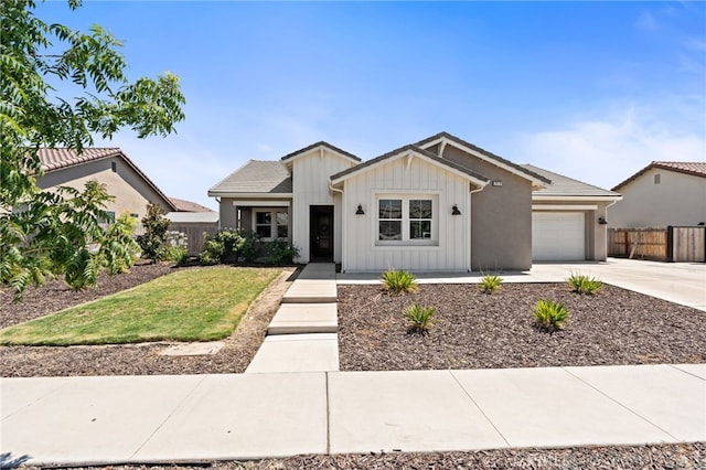 2070 Solig Ave, Kingsburg, CA 93631 - view of front of house with board and batten siding, concrete driveway, and a garage