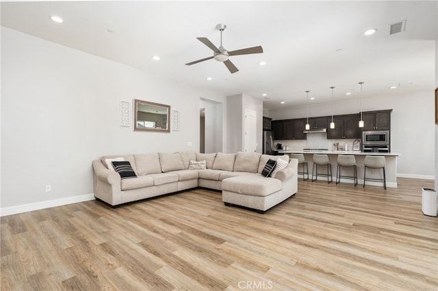 2070 Solig Ave, Kingsburg, CA 93631 - living room featuring light wood-style flooring, a ceiling fan, and recessed lighting