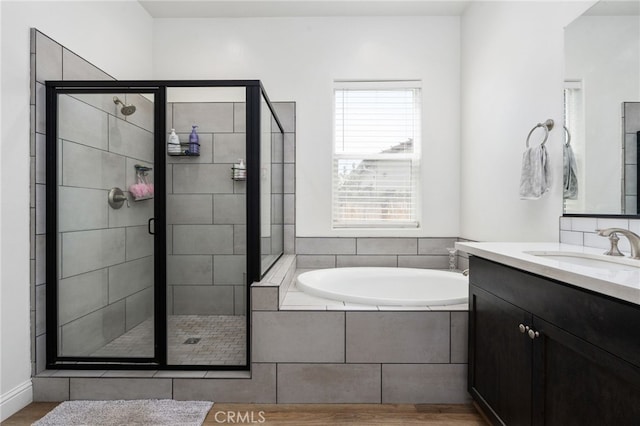 2070 Solig Ave, Kingsburg, CA 93631 - bathroom featuring a garden tub, a shower stall, vanity, and wood finished floors
