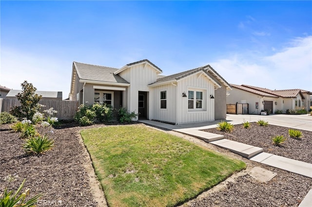 2070 Solig Ave, Kingsburg, CA 93631 - view of front of home featuring board and batten siding, concrete driveway, and a tiled roof