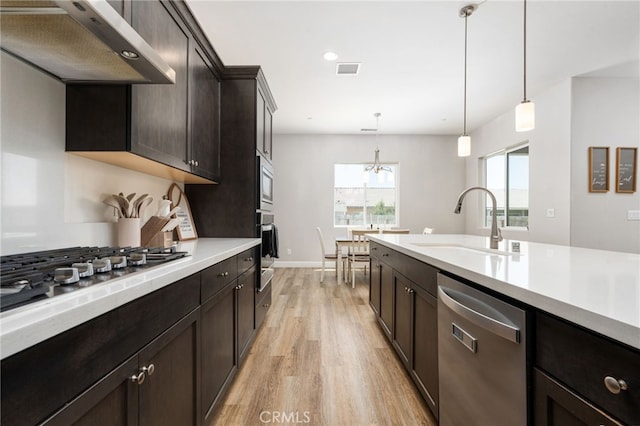 2070 Solig Ave, Kingsburg, CA 93631 - kitchen with appliances with stainless steel finishes, range hood, light wood-style flooring, light countertops, and recessed lighting