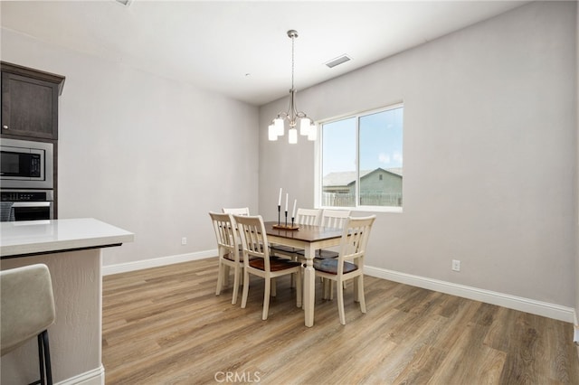 2070 Solig Ave, Kingsburg, CA 93631 - dining area with light wood finished floors and a chandelier