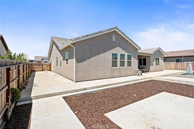 2070 Solig Ave, Kingsburg, CA 93631 - back of property featuring a patio, a fenced backyard, stucco siding, and a tile roof