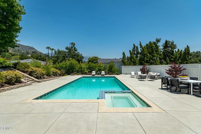 5210 La Canada Blvd, La Canada Flintridge, CA 91011 - view of pool with a patio area, a pool with connected hot tub, a mountain view, outdoor lounge area, and outdoor dining area