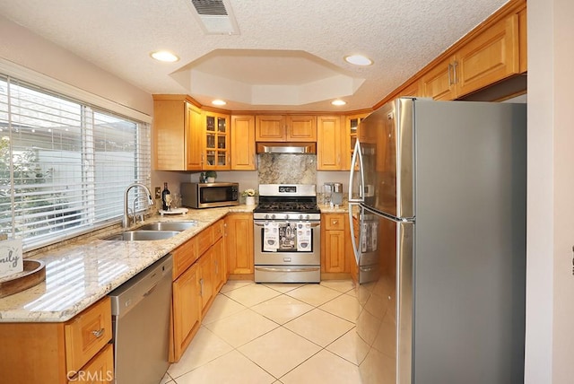 1201 W Cerritos Ave Unit 68, Anaheim, CA 92802 - kitchen featuring appliances with stainless steel finishes, a raised ceiling, light stone counters, light tile patterned floors, and recessed lighting
