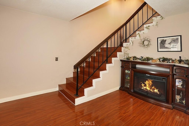 1201 W Cerritos Ave Unit 68, Anaheim, CA 92802 - stairs with wood finished floors and a glass covered fireplace