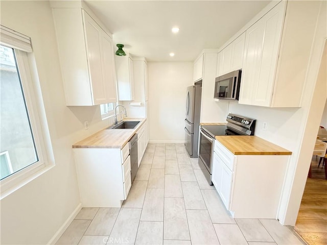 1126 N Central Ave Unit 303, Glendale, CA 91202 - kitchen featuring stainless steel appliances, butcher block counters, white cabinetry, and recessed lighting