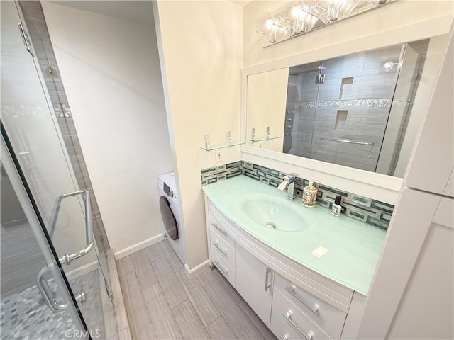 1126 N Central Ave Unit 303, Glendale, CA 91202 - bathroom featuring vanity, washer / dryer, a shower stall, and wood tiled floors