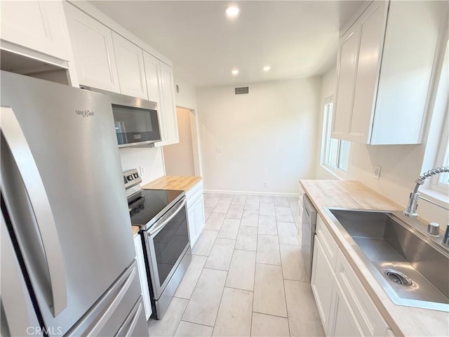 1126 N Central Ave Unit 303, Glendale, CA 91202 - kitchen featuring stainless steel appliances, white cabinets, and recessed lighting