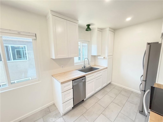 1126 N Central Ave Unit 303, Glendale, CA 91202 - kitchen with appliances with stainless steel finishes, white cabinetry, light countertops, light tile patterned flooring, and recessed lighting